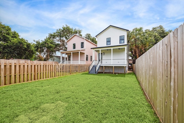 back of house featuring a porch and a yard