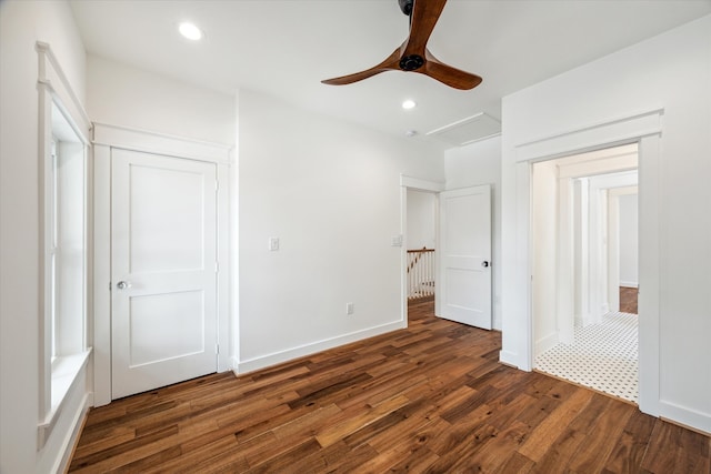 unfurnished bedroom with ceiling fan, a closet, and dark hardwood / wood-style flooring