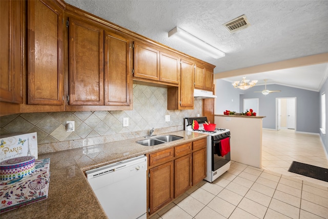 kitchen featuring sink, backsplash, white appliances, vaulted ceiling, and light tile patterned flooring