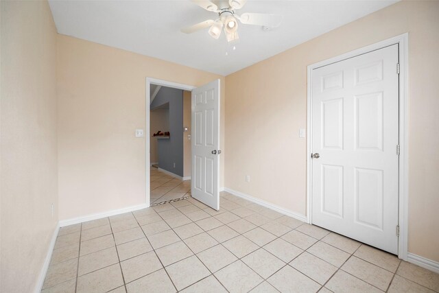 unfurnished bedroom with ceiling fan and light tile patterned floors