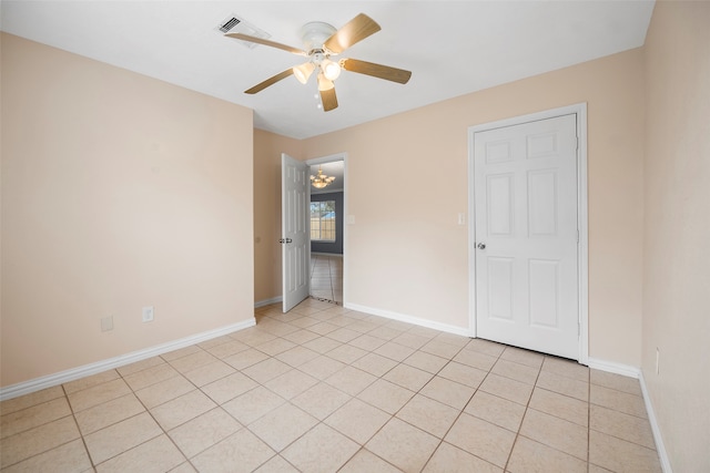 unfurnished room with ceiling fan and light tile patterned floors