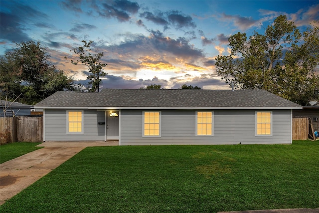 ranch-style home featuring a yard