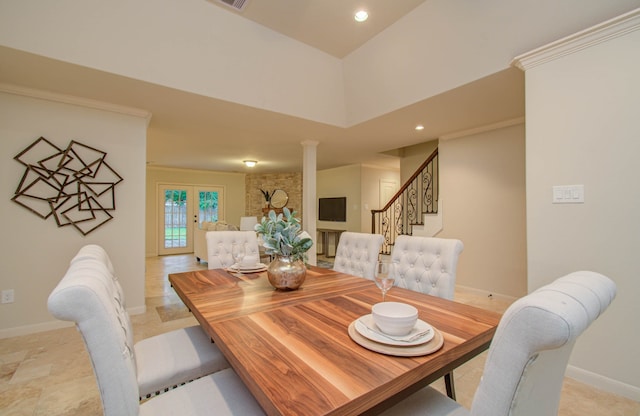 dining area featuring french doors and decorative columns