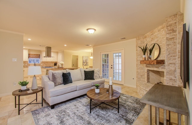 living room featuring ornamental molding and a fireplace