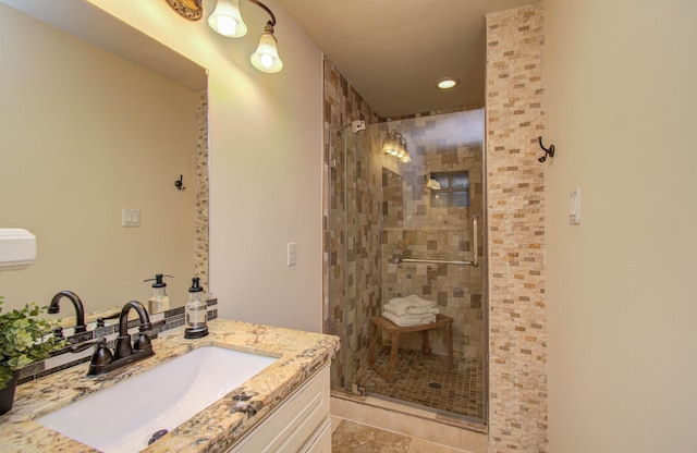 bathroom featuring walk in shower, vanity, and tile patterned floors