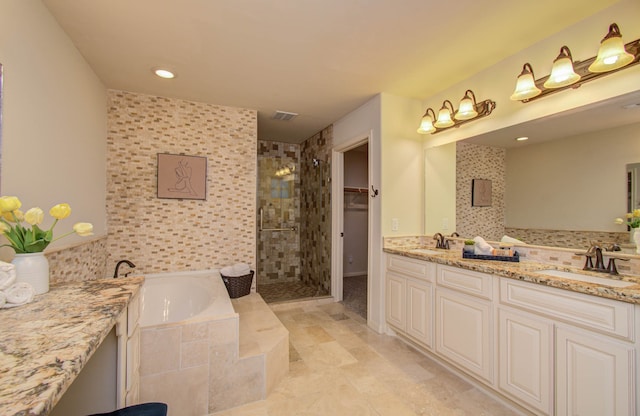 bathroom with vanity and separate shower and tub