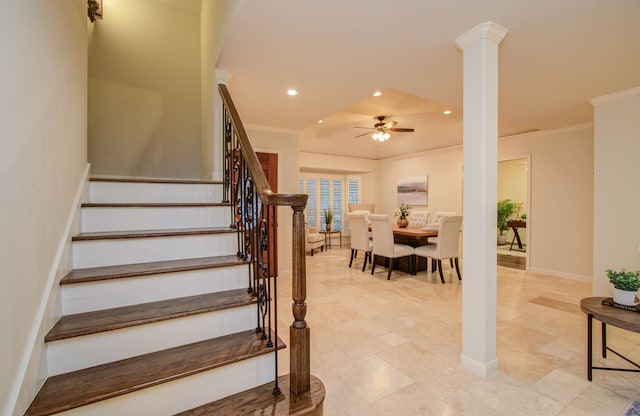 staircase featuring ceiling fan, ornate columns, and crown molding