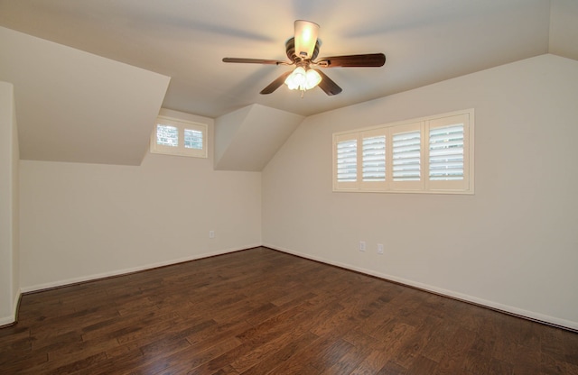 additional living space featuring dark hardwood / wood-style flooring, vaulted ceiling, and ceiling fan