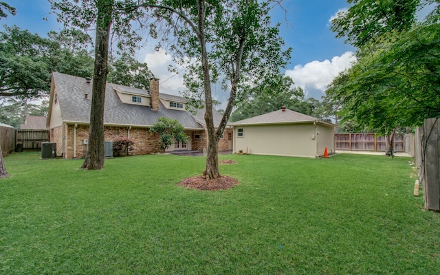 view of yard featuring cooling unit and a patio area