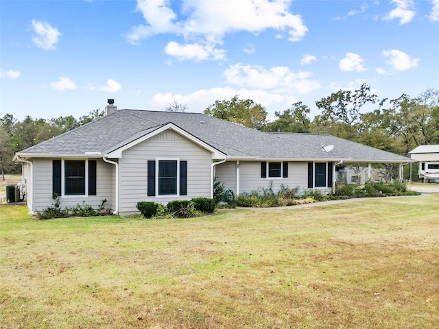 ranch-style home featuring cooling unit and a front lawn