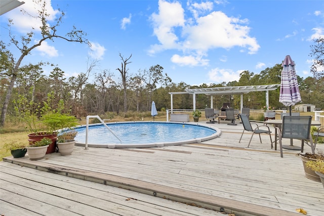 view of pool with a pergola and a wooden deck