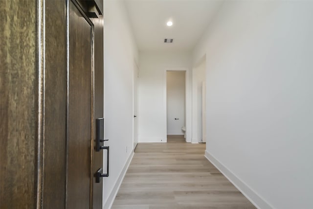 corridor with light hardwood / wood-style flooring