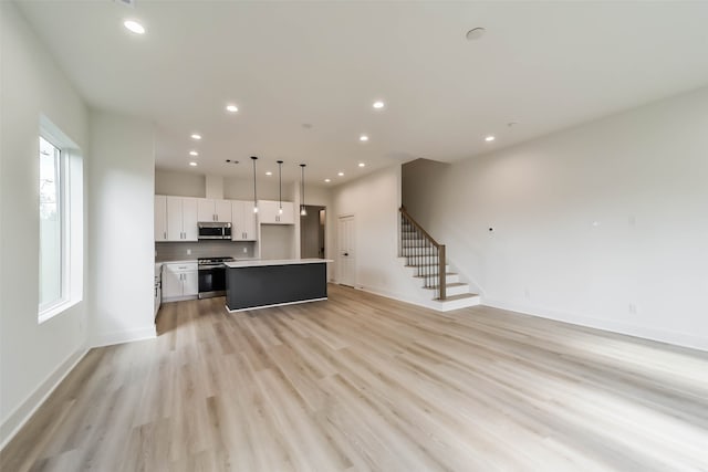 unfurnished living room with light wood-type flooring