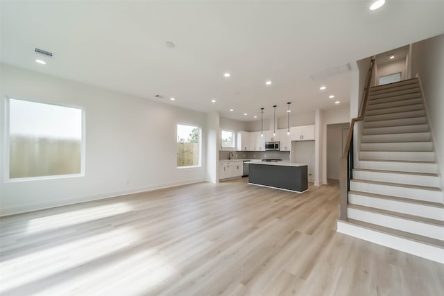 unfurnished living room with light hardwood / wood-style flooring