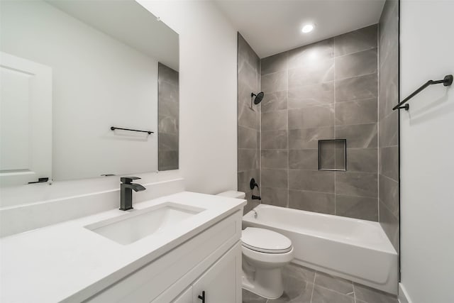 full bathroom with tile patterned floors, vanity, toilet, and tiled shower / bath combo