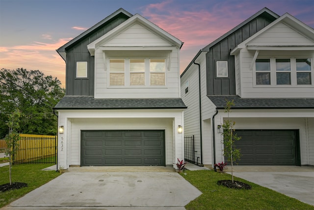 view of front of property featuring a garage and a lawn