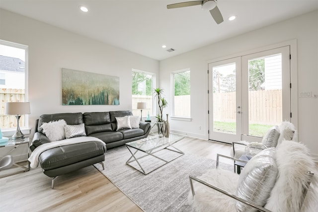 living room with french doors, ceiling fan, and light hardwood / wood-style flooring