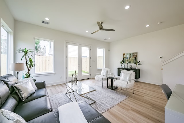 living room featuring ceiling fan and light hardwood / wood-style floors