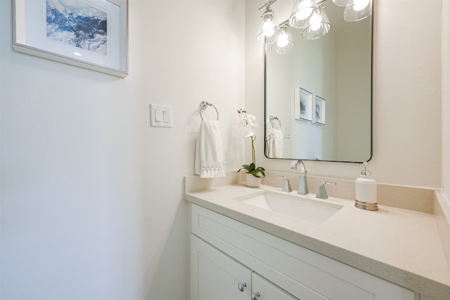 bathroom featuring a chandelier and vanity