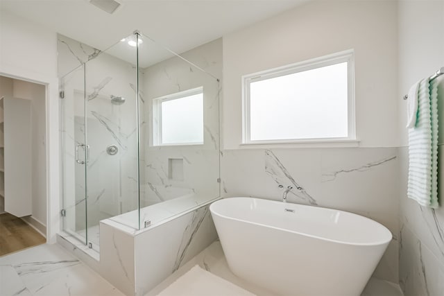 bathroom with separate shower and tub