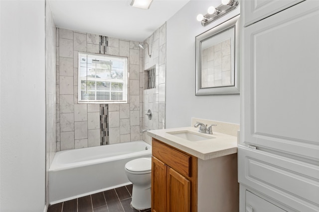 full bathroom with vanity, toilet, and tiled shower / bath