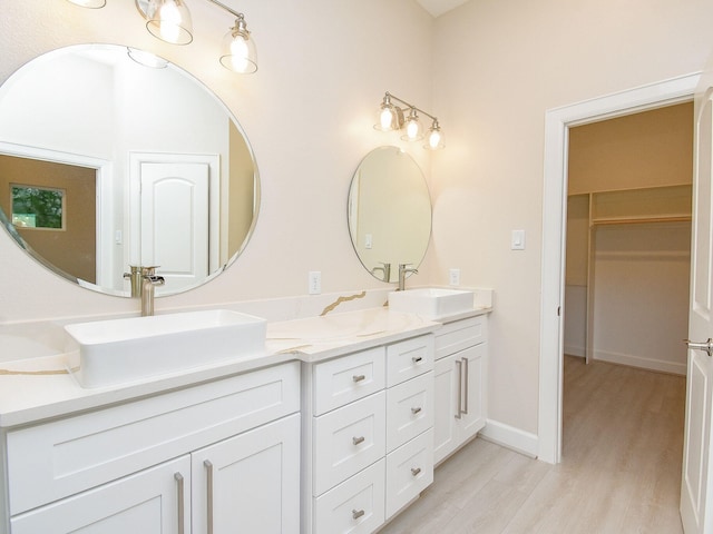 bathroom with hardwood / wood-style flooring and vanity