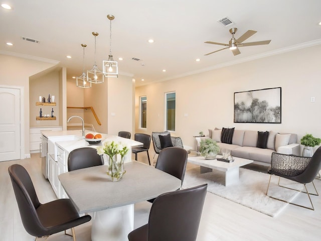 dining room featuring ceiling fan, light hardwood / wood-style flooring, and ornamental molding