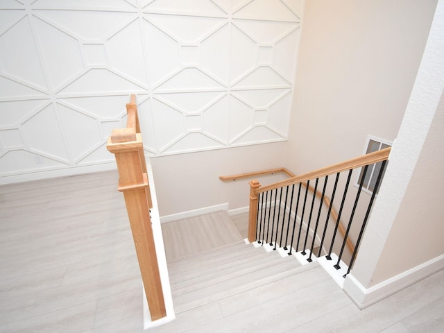 stairway with hardwood / wood-style floors