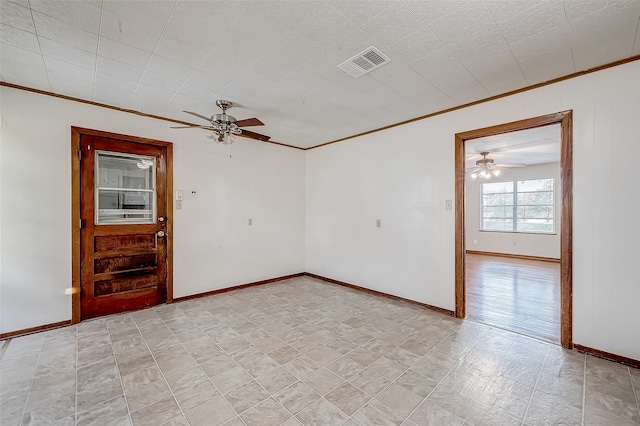 spare room with ornamental molding and ceiling fan