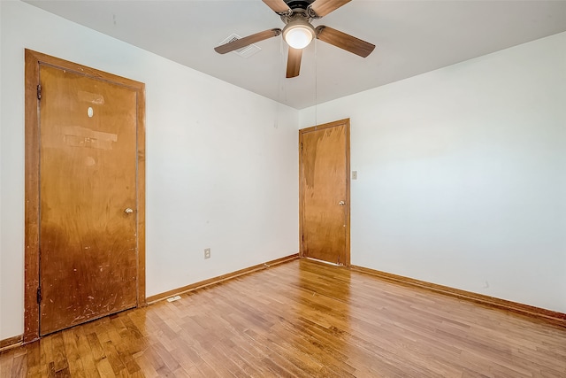 empty room featuring hardwood / wood-style floors and ceiling fan