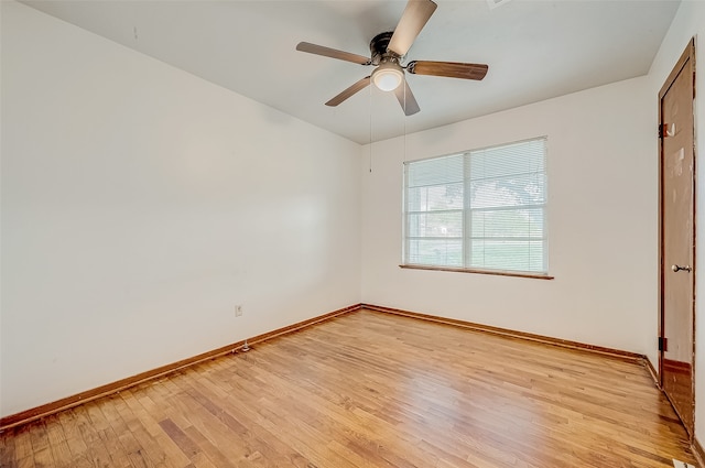 spare room featuring light wood-type flooring and ceiling fan