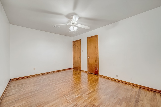 empty room with light hardwood / wood-style floors and ceiling fan