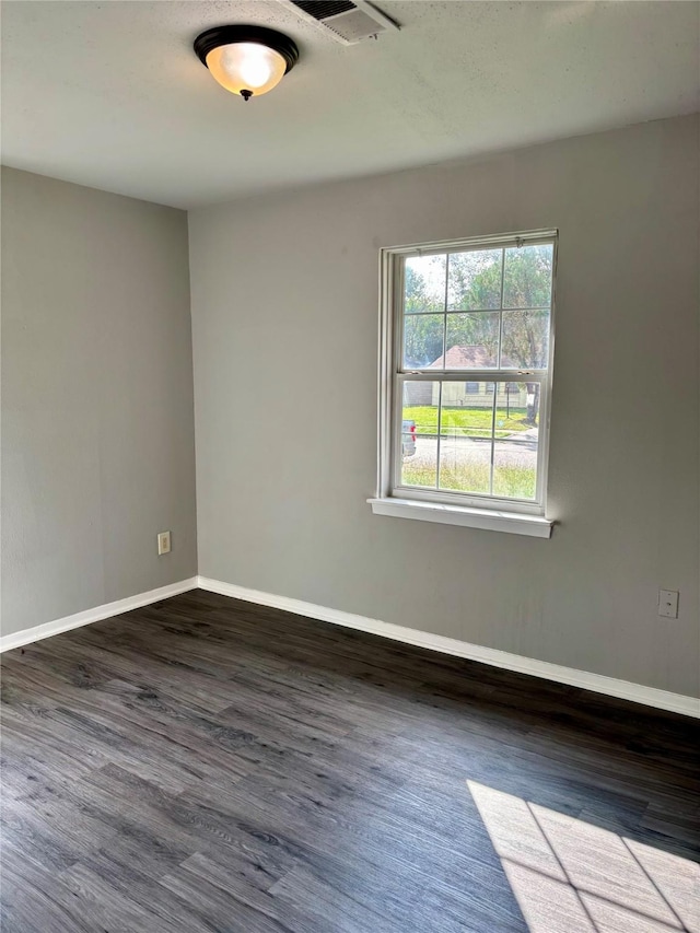 empty room with dark hardwood / wood-style floors