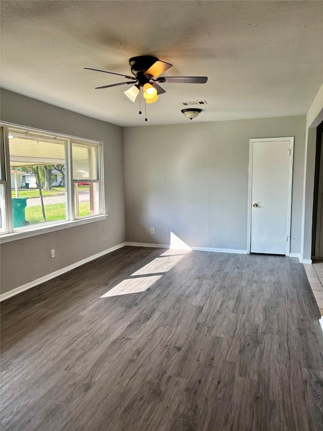 spare room featuring ceiling fan and hardwood / wood-style floors