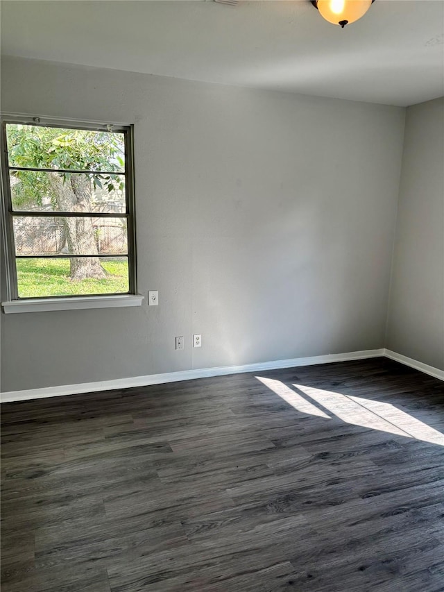 empty room with dark hardwood / wood-style floors