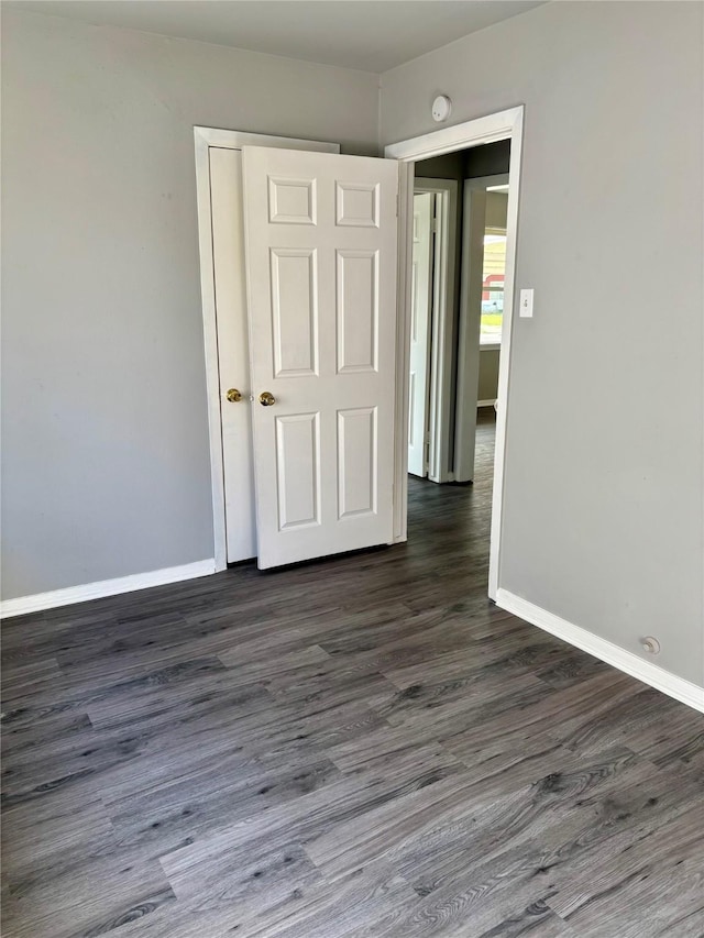 empty room featuring dark hardwood / wood-style flooring