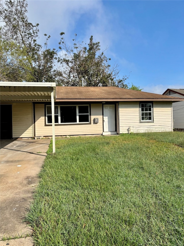 ranch-style house with a front yard and a carport