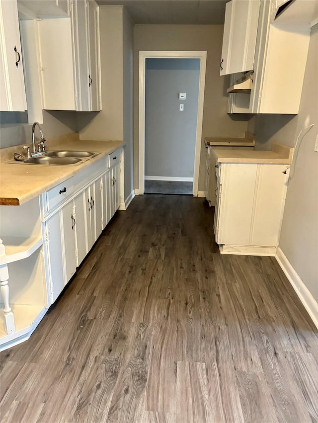 kitchen featuring white cabinets, sink, and dark wood-type flooring