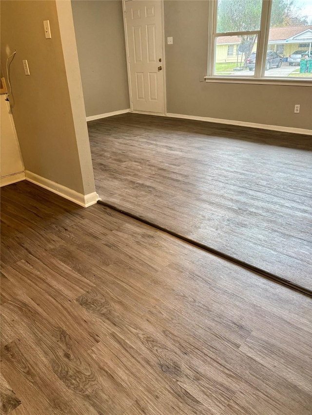 spare room featuring dark hardwood / wood-style flooring