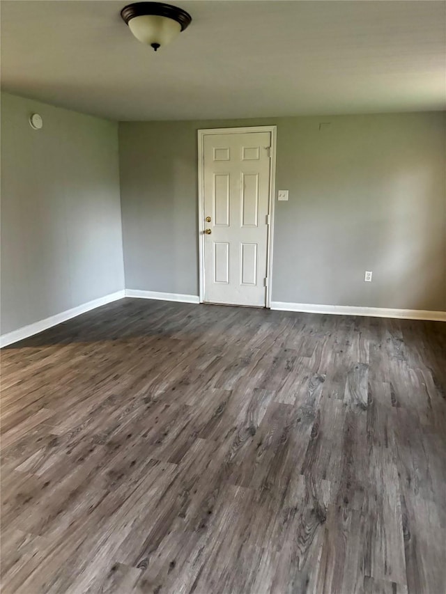 spare room featuring dark wood-type flooring