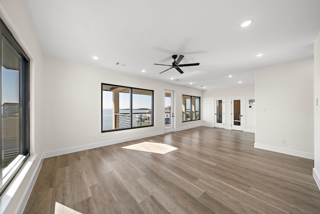 unfurnished living room featuring recessed lighting, visible vents, baseboards, and wood finished floors