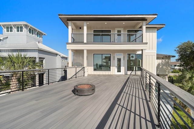 wooden terrace with a fire pit