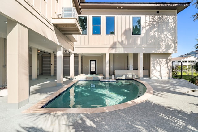 pool featuring an in ground hot tub and a patio