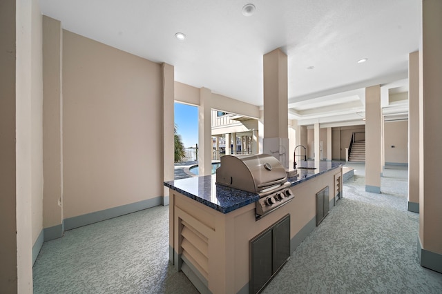 kitchen with a kitchen island and light colored carpet