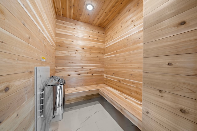 view of sauna / steam room featuring wooden walls and wooden ceiling