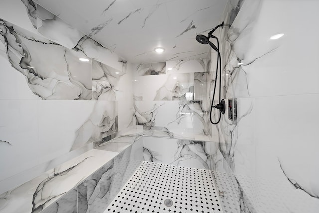 bathroom with a marble finish shower