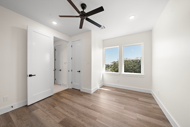 unfurnished bedroom with light wood finished floors, recessed lighting, visible vents, and baseboards