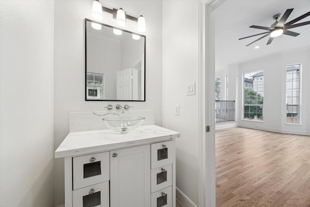 bathroom featuring ceiling fan, vanity, and hardwood / wood-style flooring