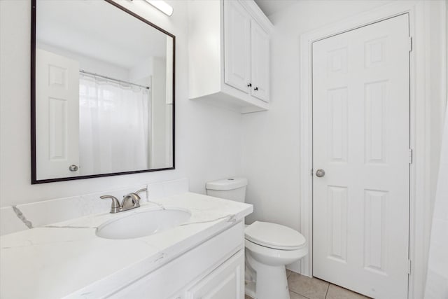 bathroom with tile patterned floors, walk in shower, vanity, and toilet