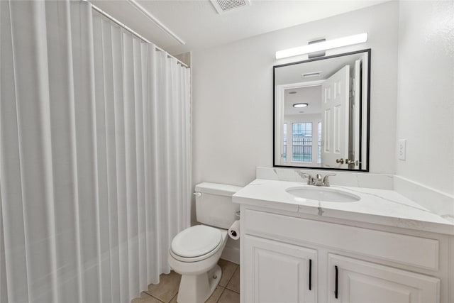 bathroom with tile patterned floors, vanity, and toilet